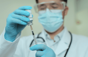 Lab researcher with syringe